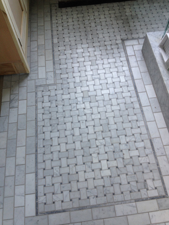 This Carrera basket weave tile floor gave this Victorian style bathroom the classic look the homeowner was looking for